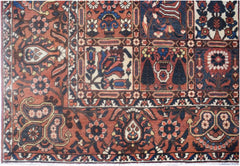 A vintage Persian rug featuring a geometric panel design with intricate floral and tribal motifs.
