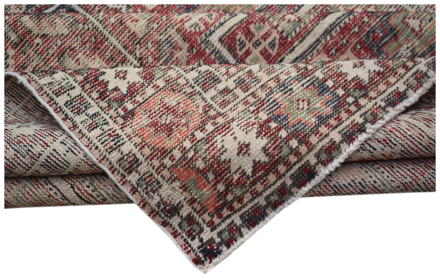 A handwoven vintage Persian rug featuring a geometric pattern in red, blue, and green tones.