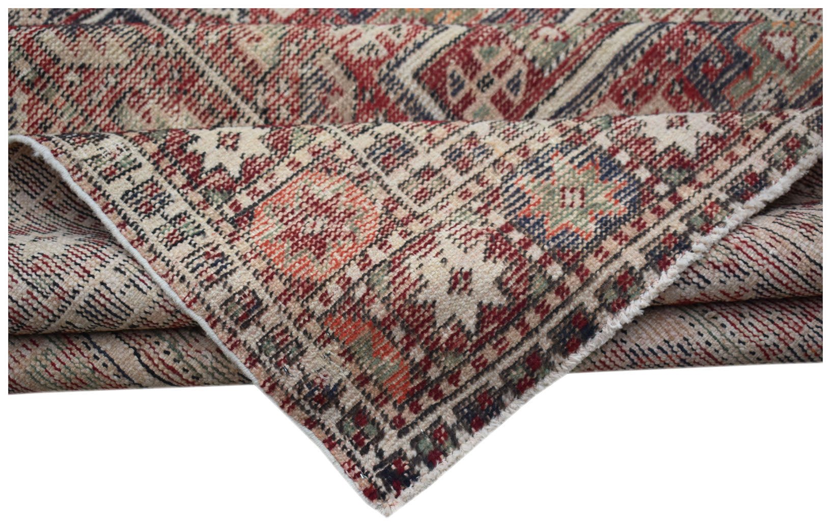 A handwoven vintage Persian rug featuring a geometric pattern in red, blue, and green tones.