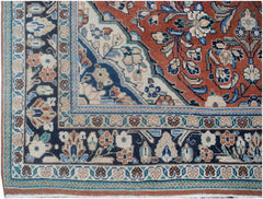 A vintage Persian rug featuring a detailed floral pattern in shades of red, blue, and cream.