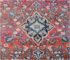 A vintage Persian rug featuring a central floral medallion on a red field with intricate patterns.