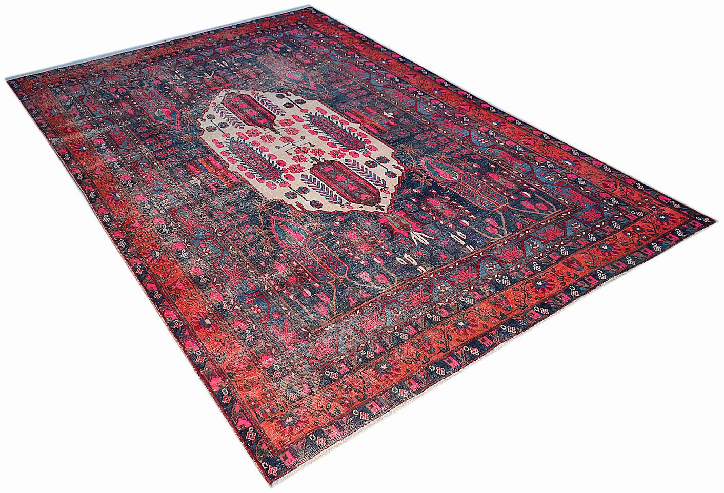 A vintage handwoven Persian rug featuring a central cream medallion on a dark blue and red field.
