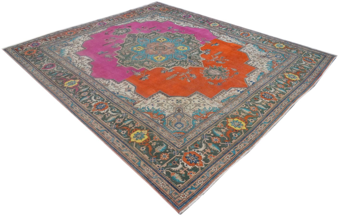 A vintage Persian rug featuring a central medallion on a split pink and orange field.