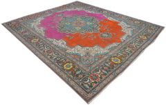 A vintage Persian rug featuring a central medallion on a split pink and orange field.