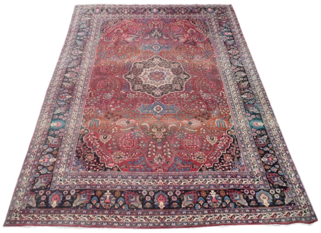 A rectangular vintage Persian rug featuring a central medallion and intricate floral patterns.