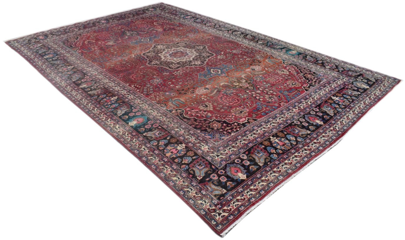 A vintage Persian rug featuring a central medallion and intricate floral patterns in red and blue.