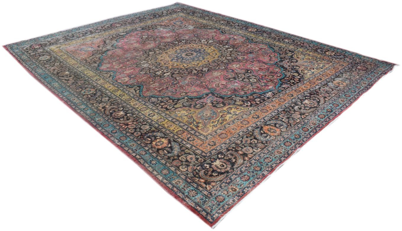 A large, handmade vintage Persian wool rug featuring a central medallion and intricate floral motifs.