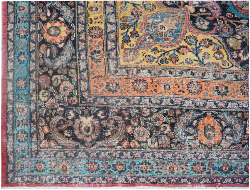 A vintage Persian wool rug featuring a detailed floral pattern in shades of blue, orange, and yellow.