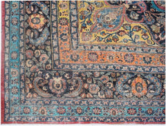 A vintage Persian wool rug featuring a detailed floral pattern in shades of blue, orange, and yellow.