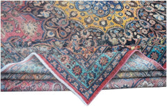 A vintage handmade Persian wool rug featuring a vibrant floral pattern in yellow, red, and blue.