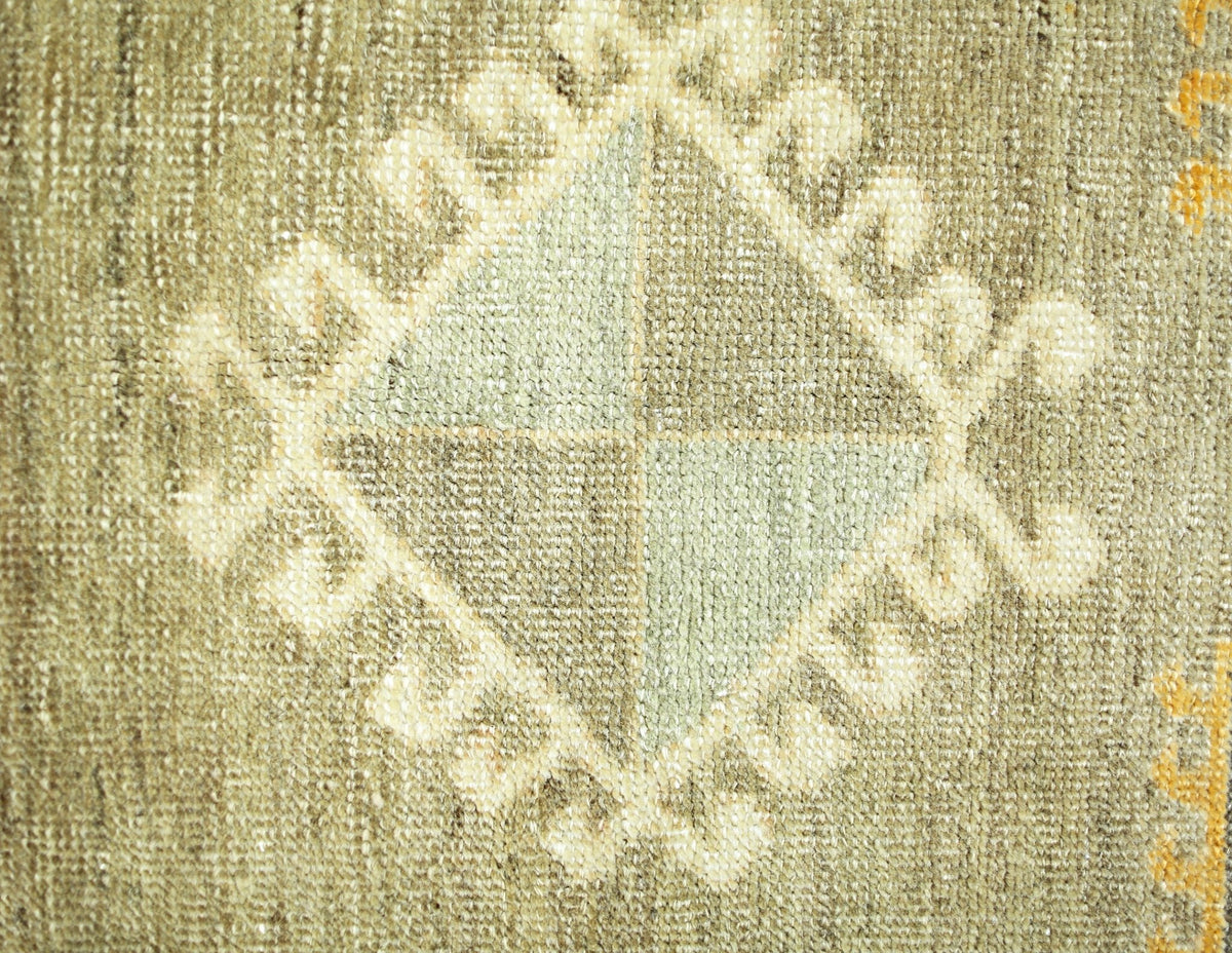 A close-up of a vintage Persian runner featuring a central diamond motif with geometric patterns.