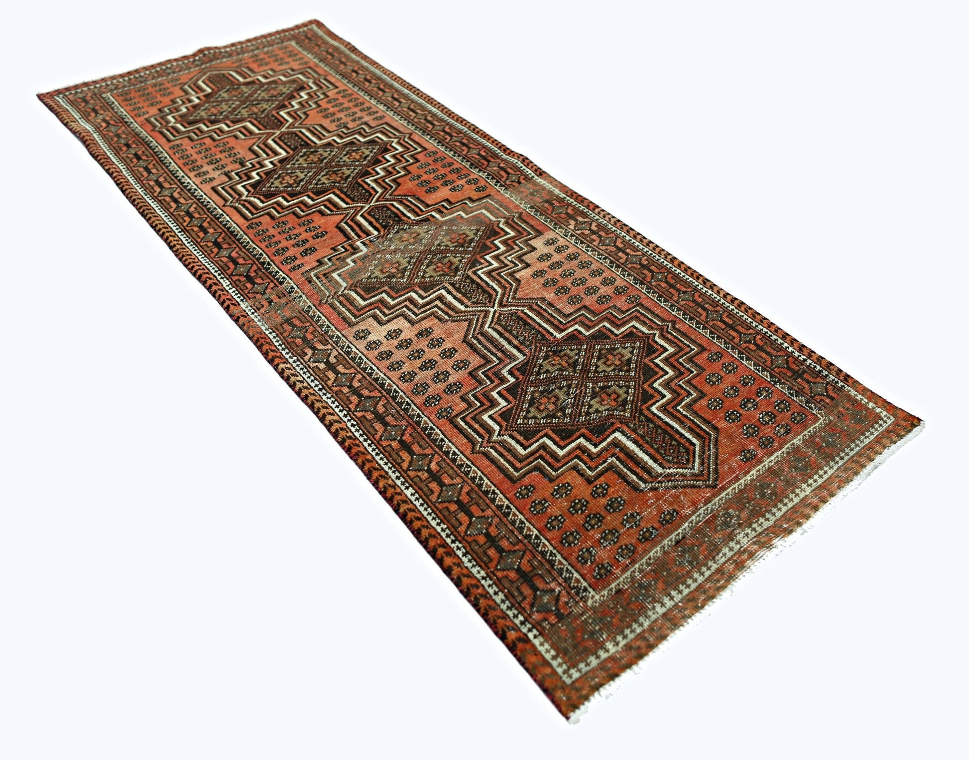 A handmade vintage Persian runner featuring geometric patterns in shades of red and brown.