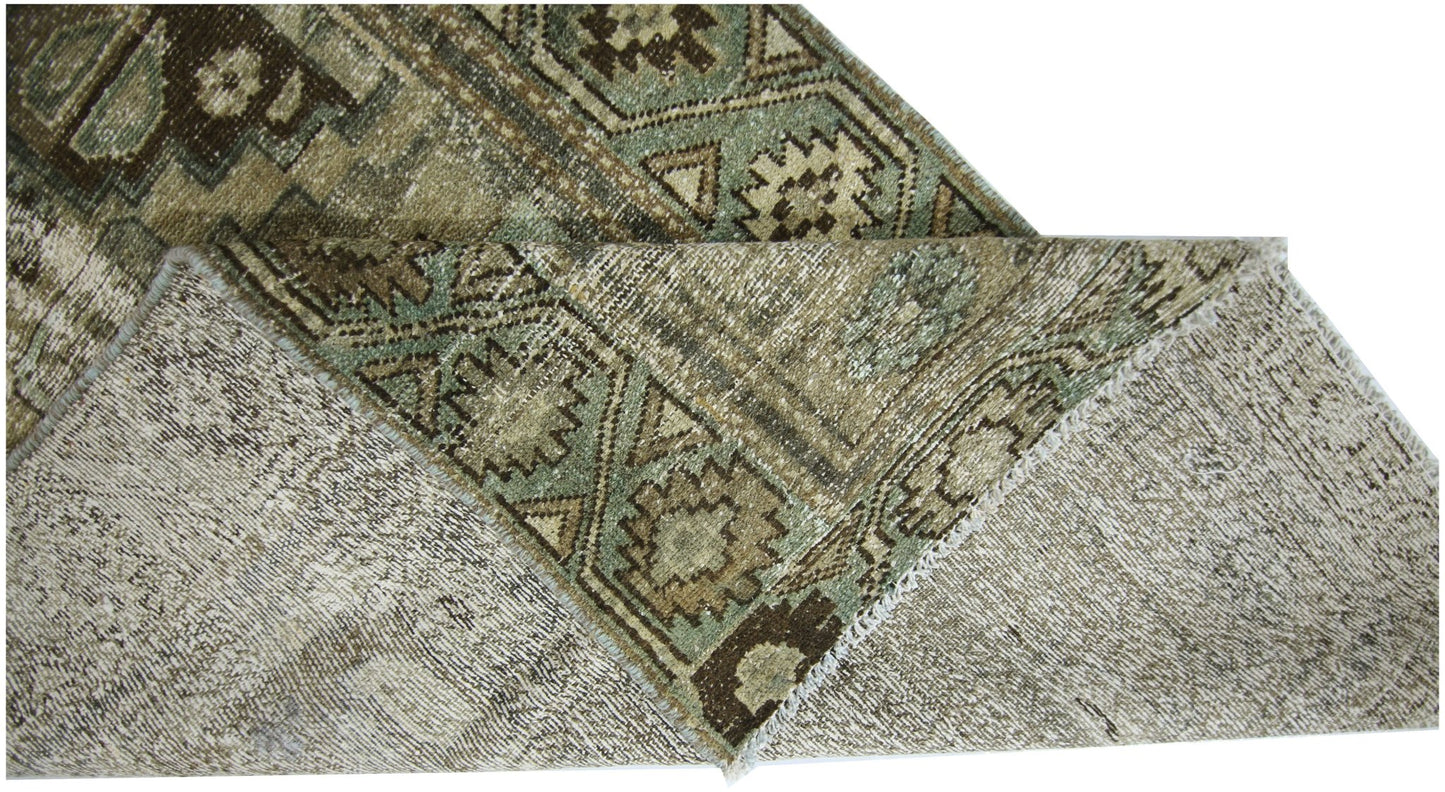 A vintage Persian runner with a geometric pattern in shades of brown and green.