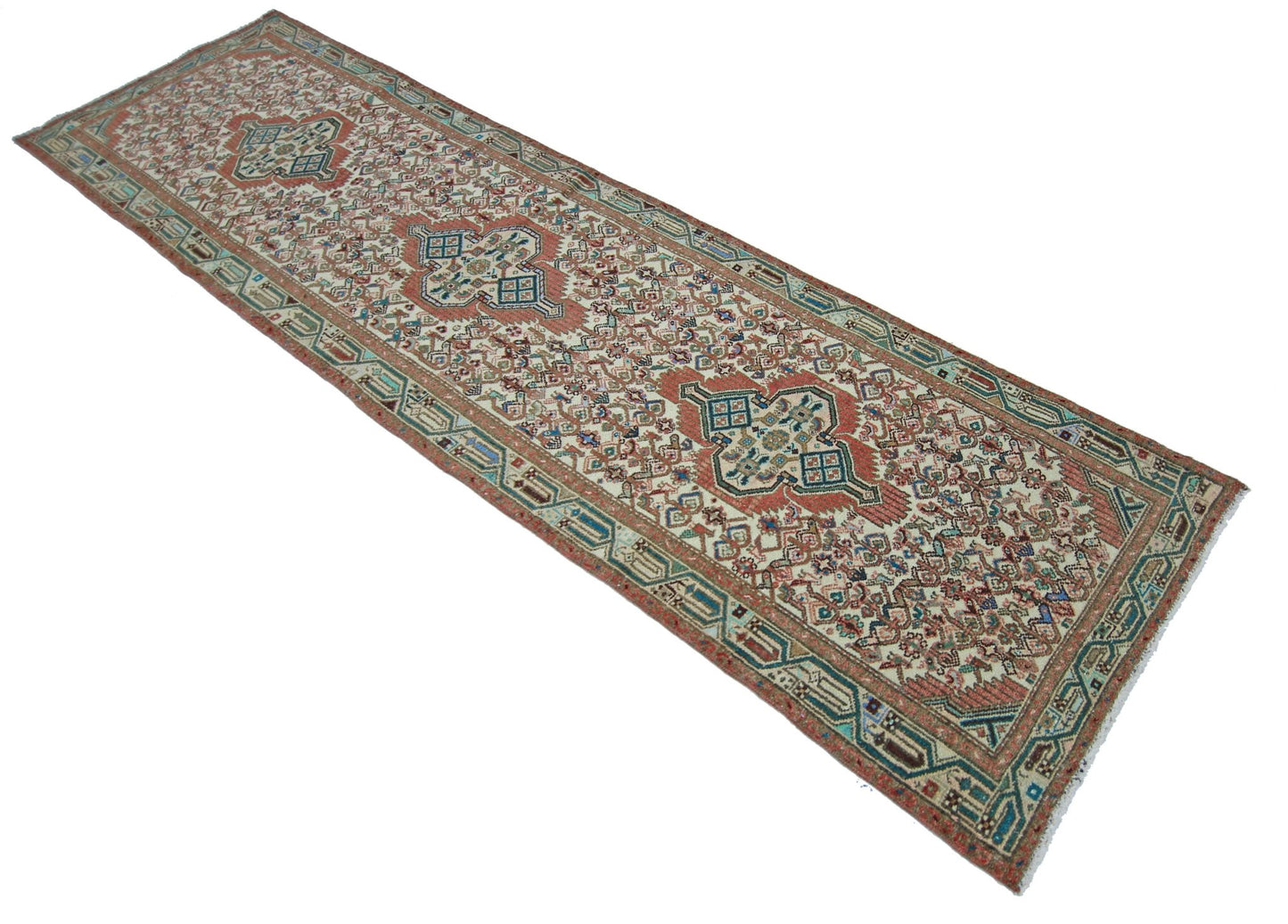 A vintage handmade Persian runner featuring a traditional floral pattern in red, blue, and cream.