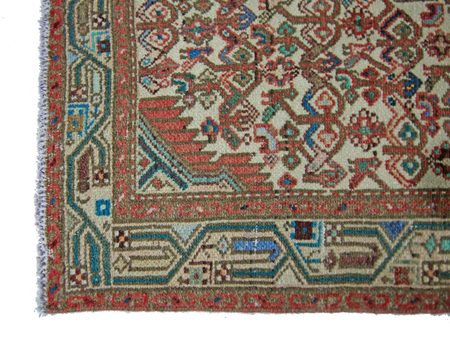 A vintage Persian runner featuring intricate geometric patterns in red, blue, and cream wool.