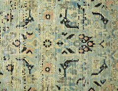 A vintage Persian runner featuring a distressed floral pattern in shades of blue and beige.