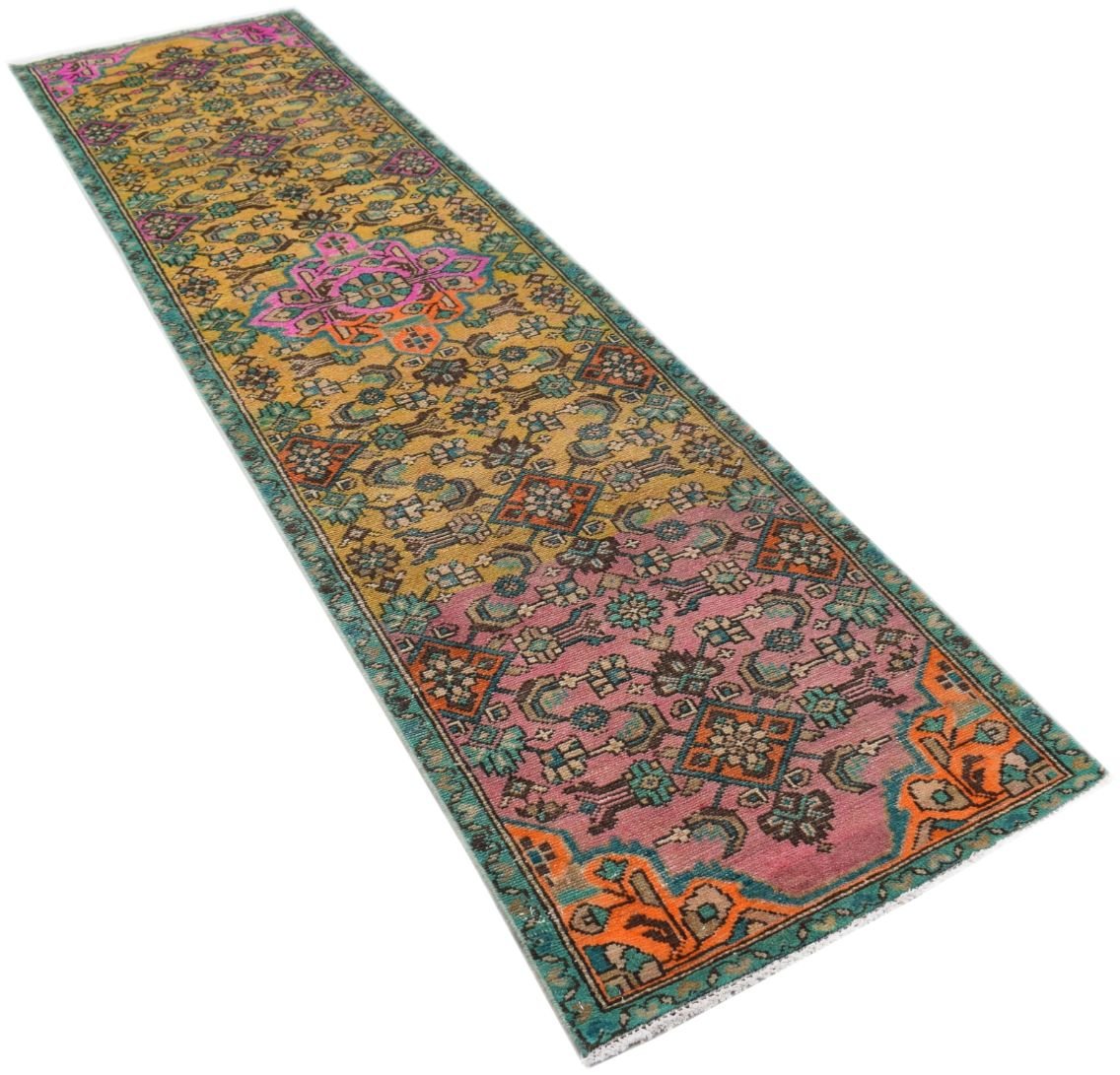 A vintage handmade Persian runner rug featuring a colorful geometric pattern in wool.