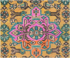 A vintage Persian runner featuring a vibrant geometric floral pattern in pink, orange, and teal.