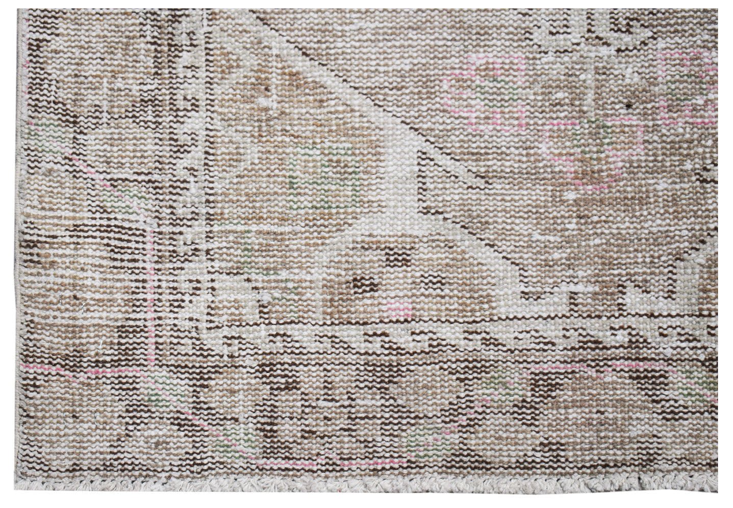 A vintage Persian runner rug featuring a faded geometric pattern in neutral tones with pink accents.