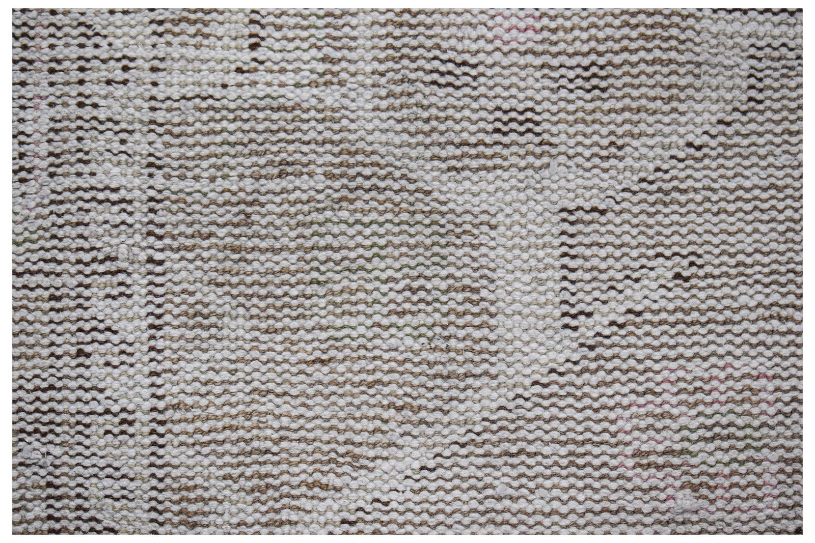 A close-up view of a vintage Persian runner featuring a faded, handwoven wool pattern.