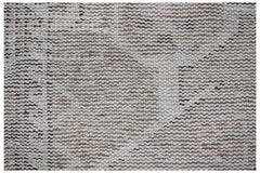 A close-up view of a vintage Persian runner featuring a faded, handwoven wool pattern.