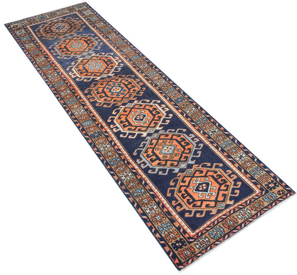 Vintage Persian runner with geometric patterns in blue and orange.