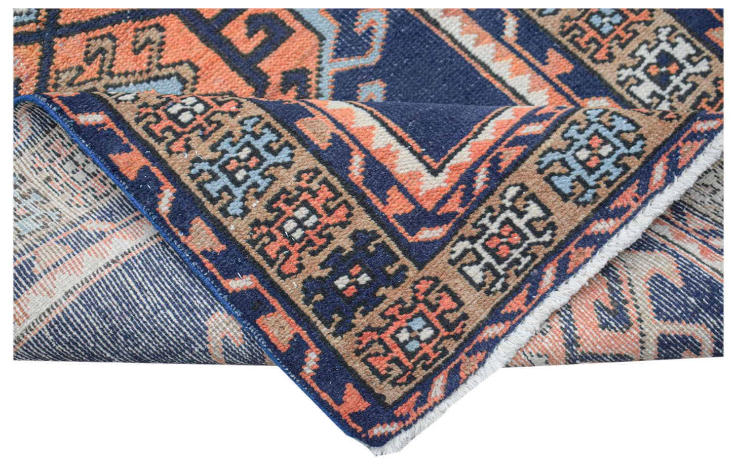 A handwoven vintage Persian runner featuring geometric patterns in blue, orange, and tan wool.