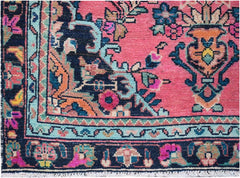 A vintage Persian runner featuring a vibrant pink field with intricate floral patterns and a dark border.
