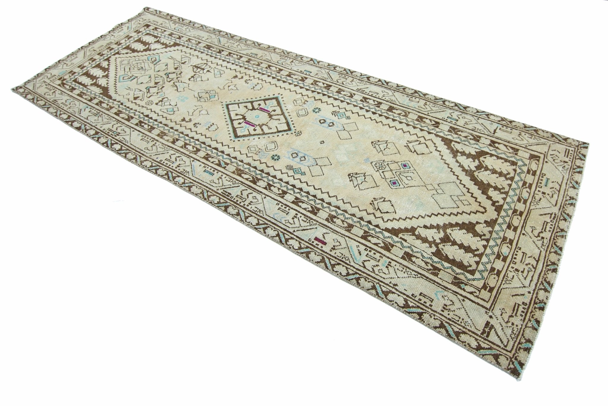 A vintage Persian runner rug featuring a geometric pattern in brown and cream tones.