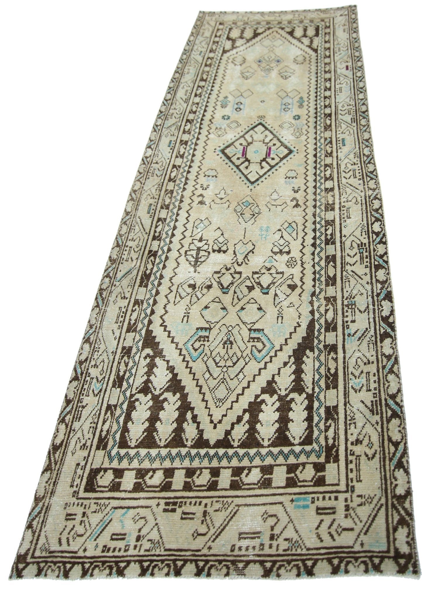 A vintage Persian runner rug featuring geometric patterns in brown, cream, and light blue.