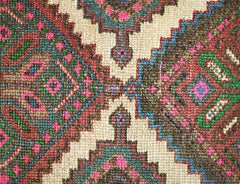 A close-up of a vintage Persian runner featuring intricate geometric patterns in vibrant colors.