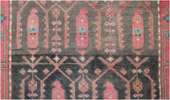 Handmade vintage Persian runner featuring a repeating tribal pattern in red on a dark brown field.