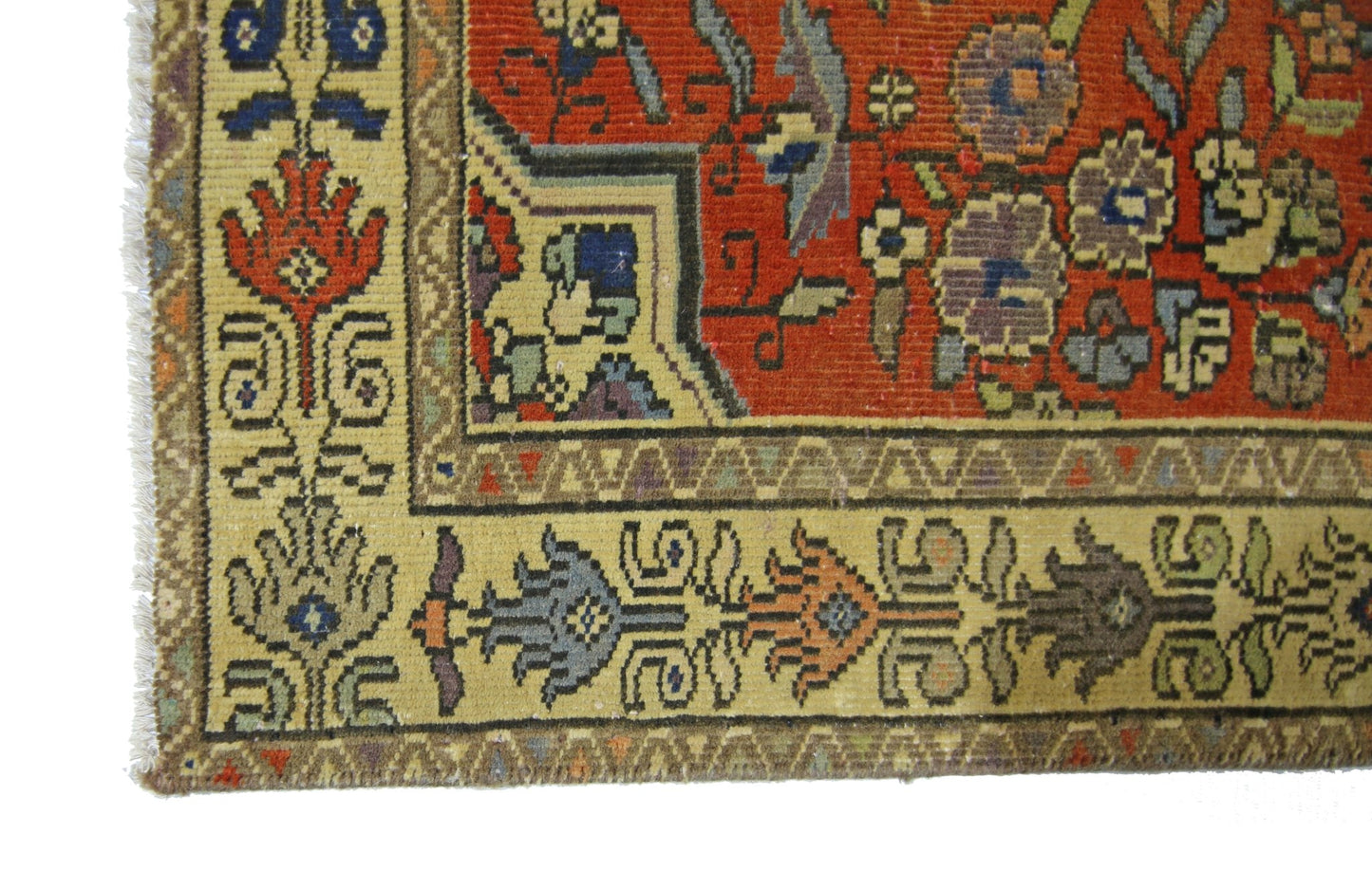 A vintage Persian runner featuring a red field with floral patterns and a tan geometric border.