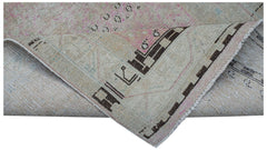 Vintage Persian runner rug with geometric patterns in brown and pink.