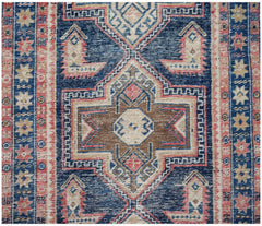 A vintage handwoven Persian runner featuring a geometric medallion pattern in blue, brown, and pink.