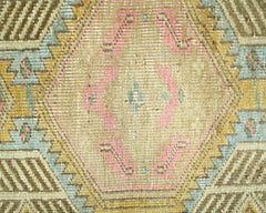 A vintage Persian runner featuring a geometric hexagonal pattern in muted pink, blue, and gold.