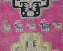 A vintage Persian runner featuring a vibrant pink field with stylized animal motifs and geometric patterns.