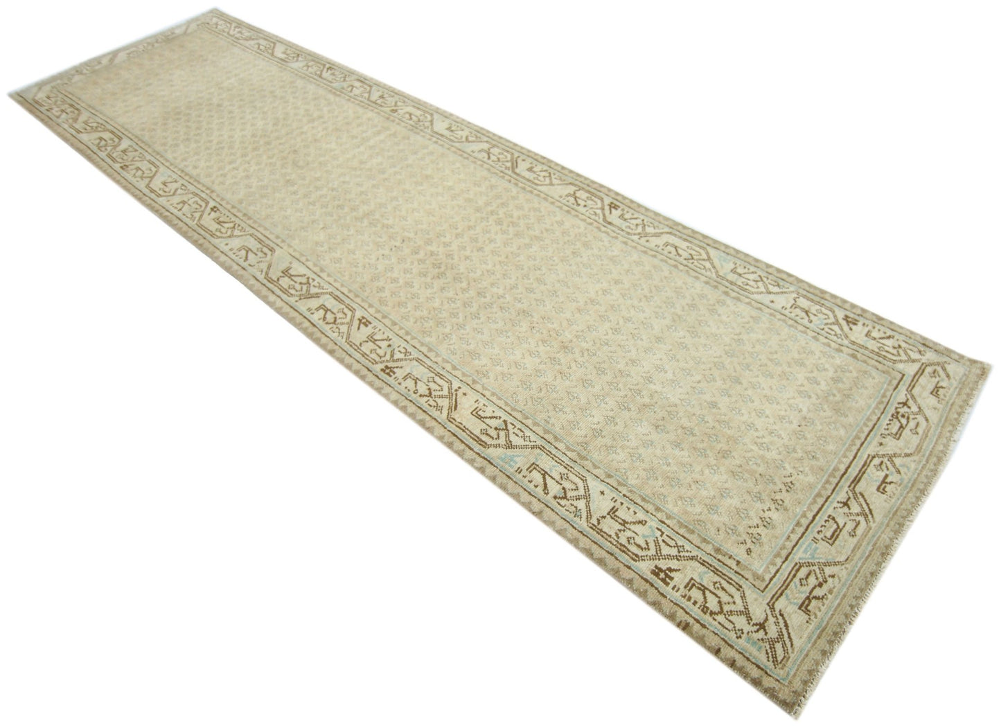 A long, handmade vintage Persian runner featuring a neutral beige palette with intricate patterns.