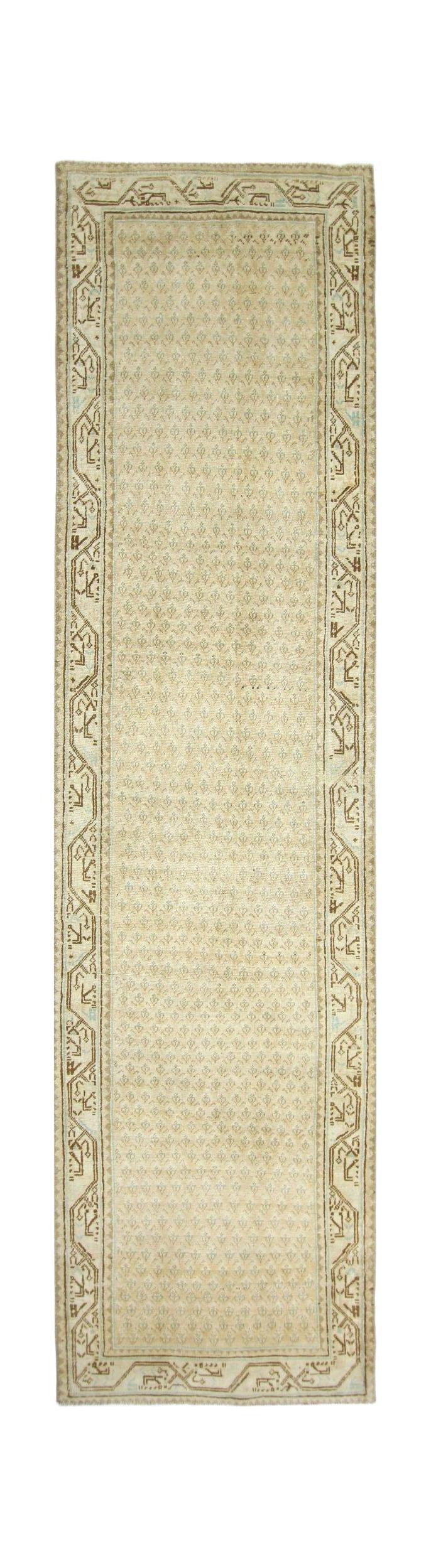 A vintage Persian runner rug featuring a repeating floral pattern in beige and soft blue tones.
