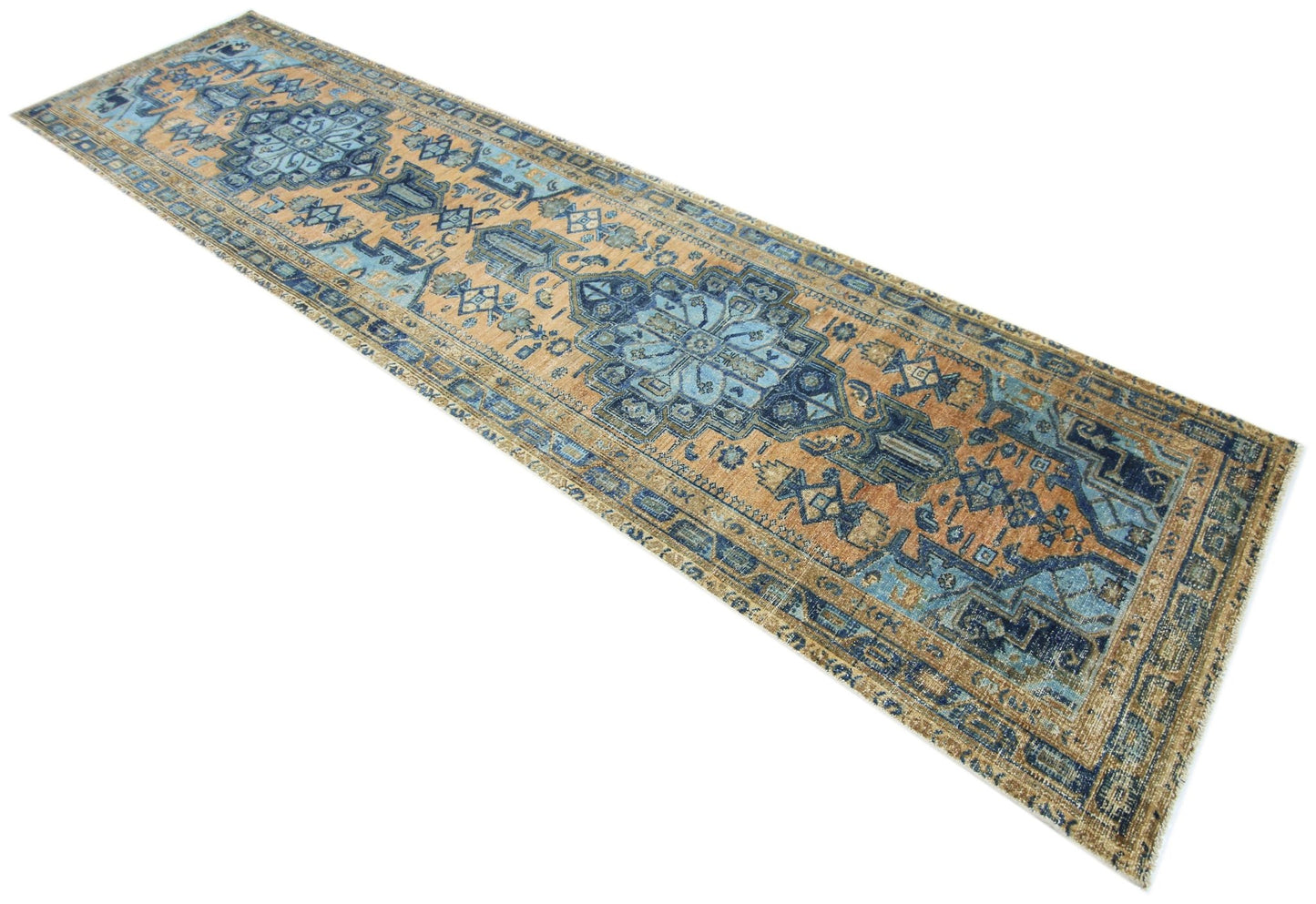 A vintage Persian runner rug featuring intricate blue and tan geometric patterns.