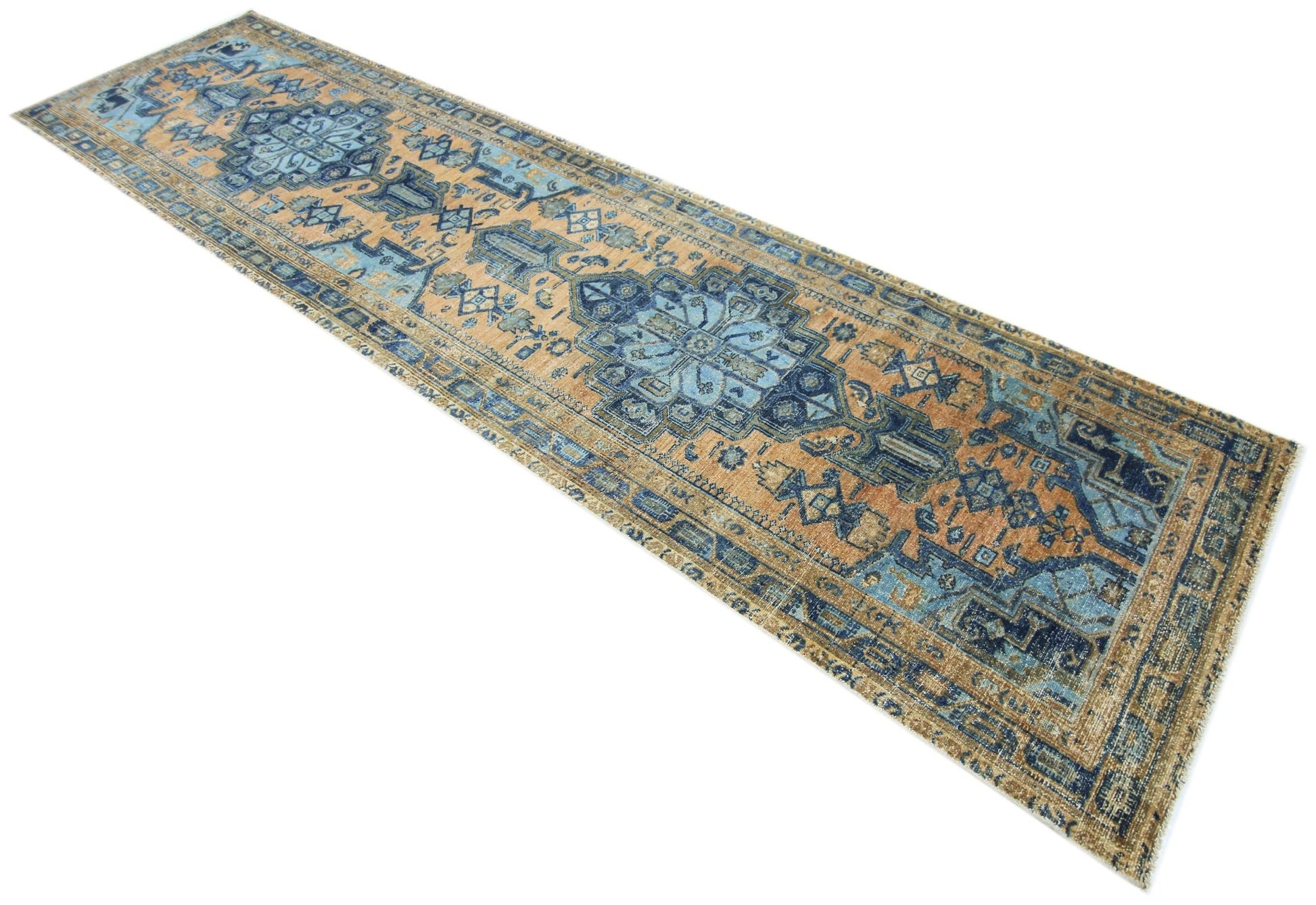A vintage Persian runner rug featuring intricate blue and tan geometric patterns.