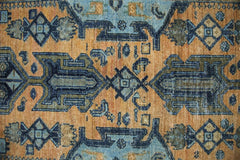 A vintage Persian runner featuring geometric patterns in shades of orange, blue, and olive green.