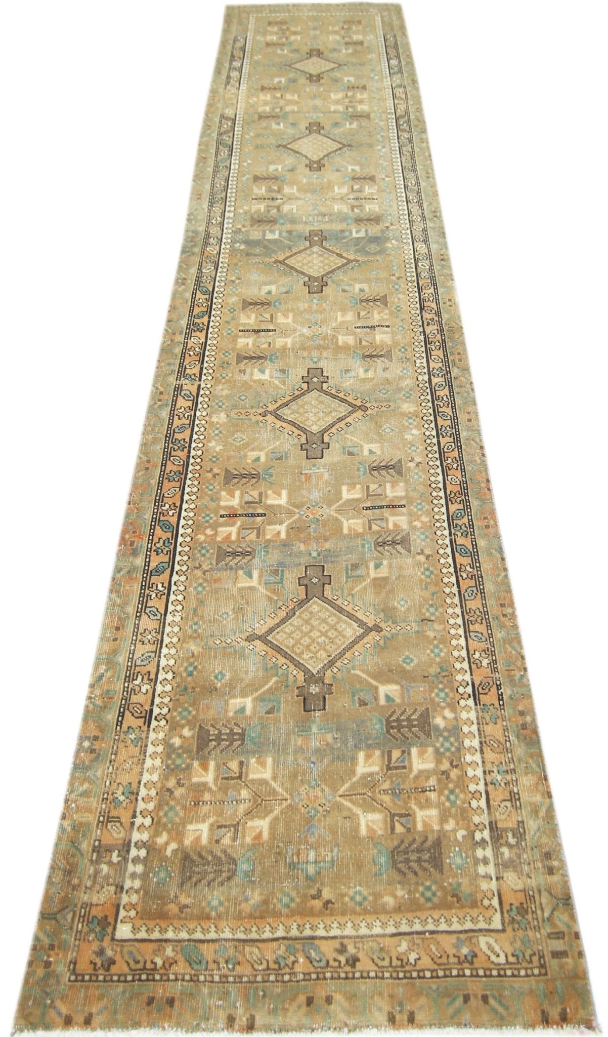 A long, handmade vintage Persian runner featuring geometric diamond motifs in muted earth tones.