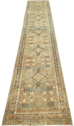 A long, handmade vintage Persian runner featuring geometric diamond motifs in muted earth tones.