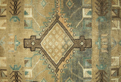 A vintage Persian runner featuring a geometric diamond pattern in muted brown and blue tones.