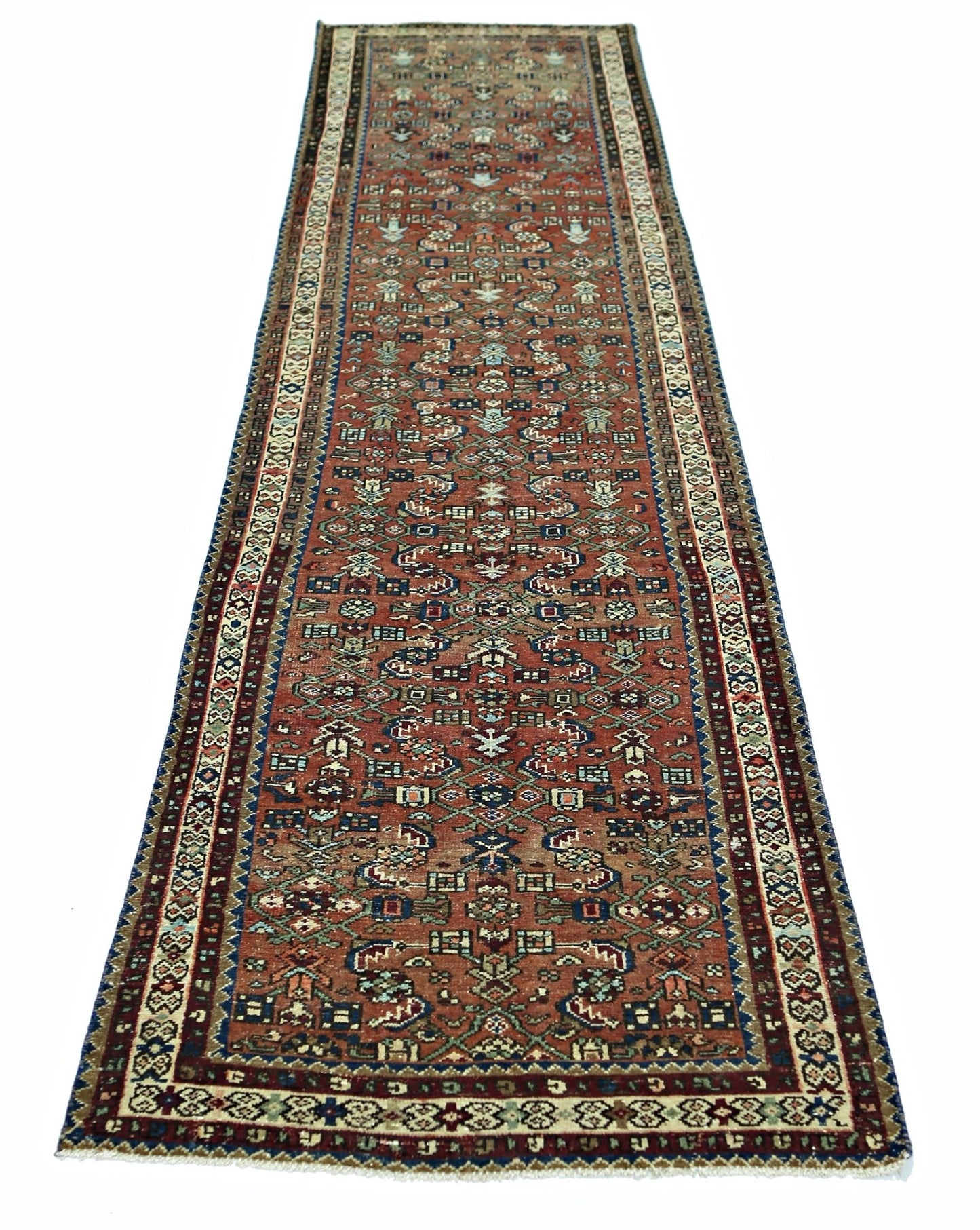 A vintage Persian runner rug featuring intricate geometric patterns in shades of red and blue.