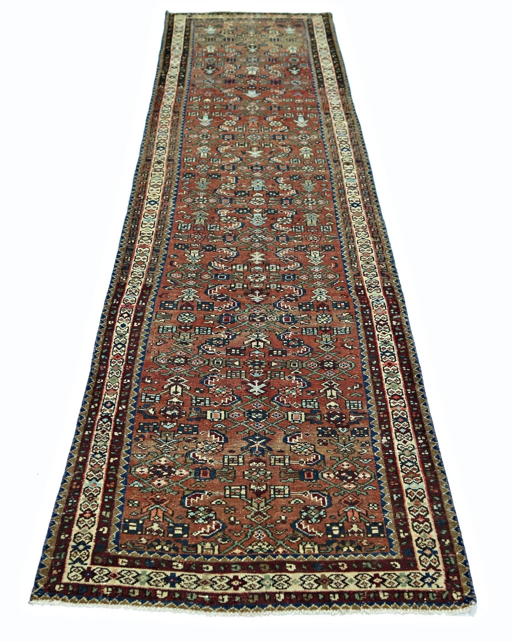 A vintage Persian runner rug featuring intricate geometric patterns in shades of red and blue.