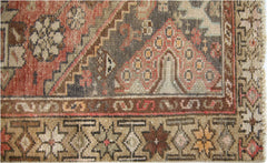 A close-up of a vintage Persian runner featuring intricate geometric patterns in earthy tones.