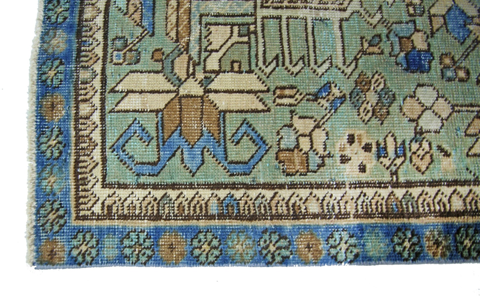 A vintage Persian runner featuring intricate floral patterns in shades of blue, green, and tan.