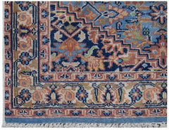 A vintage Persian runner featuring a geometric floral pattern in blue, orange, and cream tones.